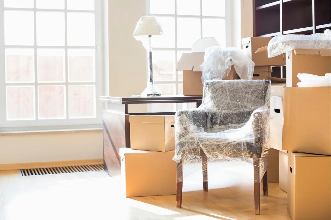Boxes and a wrapped armchair on install day